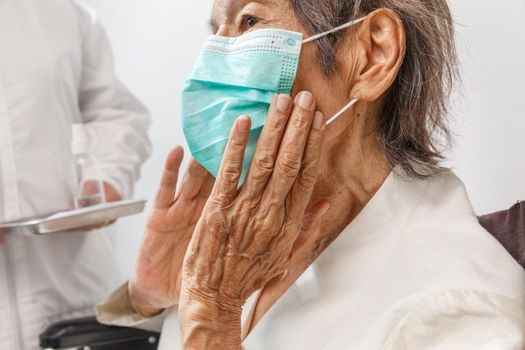 Elderly woman wearing a mask to protect from coronavirus covid-19