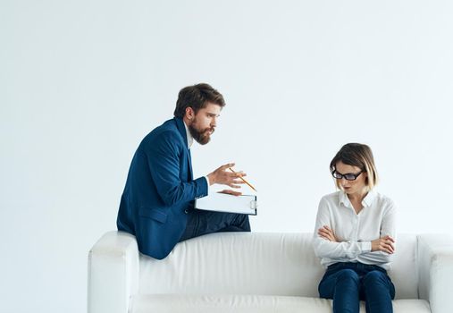 Work colleagues sit on the couch communicating lifestyle interior emotions. High quality photo