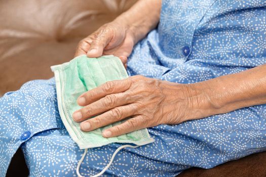 Elderly woman wearing a mask to protect from coronavirus covid-19