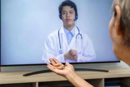 Elderly woman sit at home having online consultation with doctor