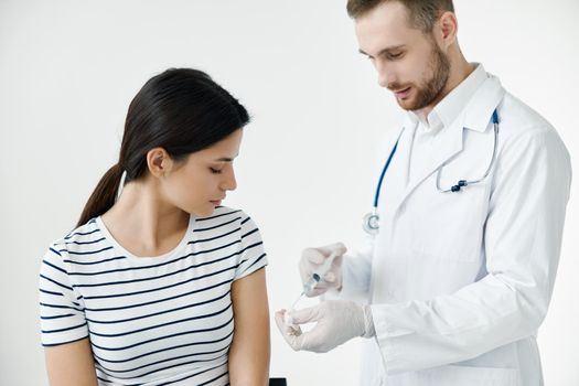 man giving an injection to a patient in the shoulder vaccination health . High quality photo