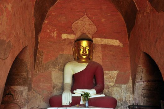 BAGAN, MYANMAR - NOVEMBER 18, 2015: Huge colored statue of Buddha in temple, From below shot of colorful Buddha statue in ornamental temple. Mingalazedi Sulamani Shwezigon Ananda Htilominlo