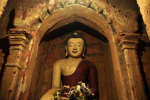 BAGAN, MYANMAR - NOVEMBER 18, 2015: Huge colored statue of Buddha in temple, From below shot of colorful Buddha statue in ornamental temple. Mingalazedi Sulamani Shwezigon Ananda Htilominlo