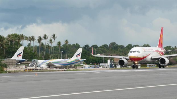 KOH SAMUI ISLAND, THAILAND - 23 JUNE 2019 White airplanes flying and landing on airport runway of Bangkok Airways company in exotic touristic resort. Vacation, travel and transportation concept.