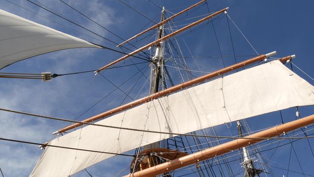 SAN DIEGO, CALIFORNIA USA - 30 JAN 2020: Retro sailing ship Star of India, full rigged wooden masts of Maritime Museum. Historic British frigate with white sails and ropes. Old large barque sailboat.