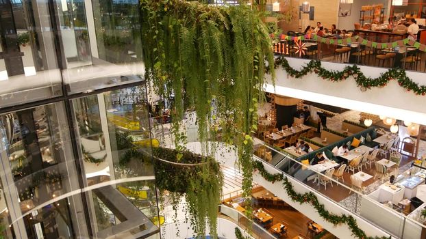 BANGKOK, THAILAND - 18 DECEMBER, 2018 The Emquartier luxury shopping center. Design of mall, green environmentally friendly concept. hanging garden, futuristic eco architecture. Modern city. Escalator