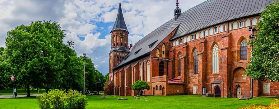 Kaliningrad , Russia. Panorama with a view of the famous Cathedral surrounded by lush summer greenery.