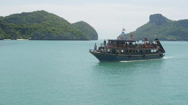 ANG THONG MARINE PARK, SAMUI, THAILAND - 9 JUNE 2019: Group of Islands in ocean near touristic paradise tropical resort. Idyllic turquoise sea with boat with tourists. Travel vacation holiday concept.