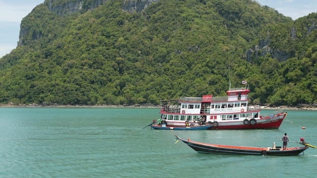 ANG THONG MARINE PARK, SAMUI, THAILAND - 9 JUNE 2019: Group of Islands in ocean near touristic paradise tropical resort. Idyllic turquoise sea with boat with tourists. Travel vacation holiday concept.