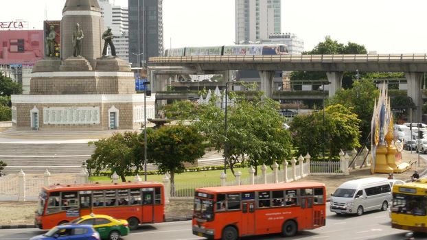 BANGKOK, THAILAND - 10 JULY, 2019: Rush hour traffic near Victory Monumet in Krungthep capital. Famous asian landmark and travel destination. Downtown modern city life. People and passengers of bts