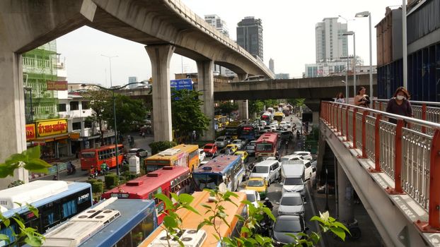 BANGKOK, THAILAND - 10 JULY, 2019: Rush hour traffic near Victory Monumet in Krungthep capital. Famous asian landmark and travel destination. Downtown modern city life. People and passengers of bts