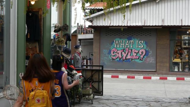 BANGKOK, THAILAND - 10 JULY, 2019: People walking at the Camp vintage flea market near Chatuchak. Design of retro style boutique art shops of antiques. Decoration of popular fashion city landmark