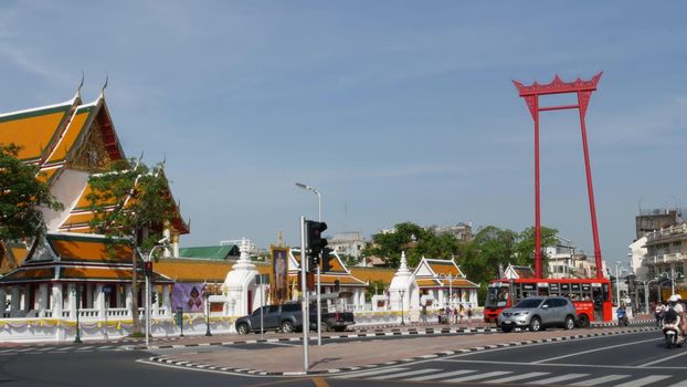 BANGKOK, THAILAND - 11 JULY, 2019: Giant Swing religios historic monument near traditional wat Suthat buddist temple. Iconic city view, cultural symbol. Famous landmark and classic tourist attraction