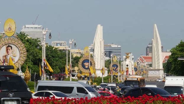 BANGKOK, THAILAND - 11 JULY, 2019: Rush hour traffic near Democracy Monument in capital. Famous asian landmark and travel destination. Democratic and patriotic symbol and public transport in downtown.