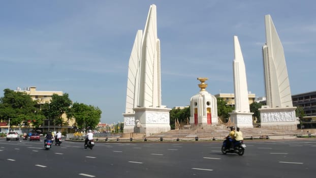 BANGKOK, THAILAND - 11 JULY, 2019: Rush hour traffic near Democracy Monument in capital. Famous asian landmark and travel destination. Democratic and patriotic symbol and public transport in downtown.