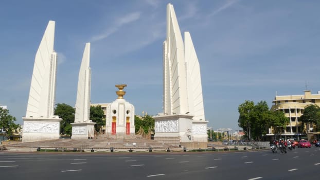 BANGKOK, THAILAND - 11 JULY, 2019: Rush hour traffic near Democracy Monument in capital. Famous asian landmark and travel destination. Democratic and patriotic symbol and public transport in downtown.