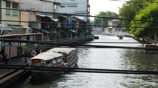 BANGKOK, THAILAND, 11 JULY 2019: Canal as classic typical water way for public passengers transportation. Street city life on khlong. Local people use boat as traditional transport during traffic jam.
