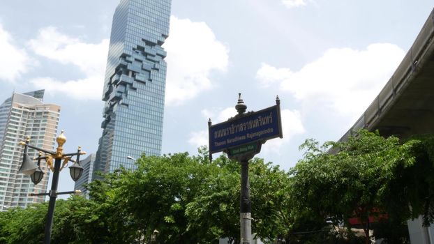 BANGKOK, THAILAND - 13 JULY, 2019: Mahanakhon King Power skyscraper in modern Sathorn financial business district. Maha Nakhon - tallest futuristic building. Rush hour traffic, cars and bts skytrain.