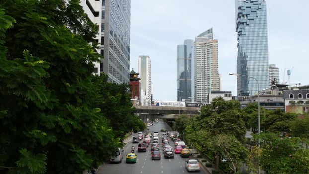 BANGKOK, THAILAND - 13 JULY, 2019: Mahanakhon King Power skyscraper in modern Sathorn financial business district. Maha Nakhon - tallest futuristic building. Rush hour traffic, cars and bts skytrain.