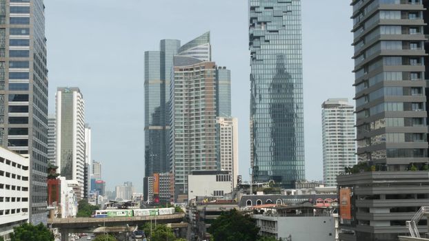 BANGKOK, THAILAND - 13 JULY, 2019: Mahanakhon King Power skyscraper in modern Sathorn financial business district. Maha Nakhon - tallest futuristic building. Rush hour traffic, cars and bts skytrain.