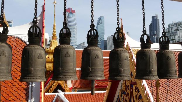 BANGKOK, THAILAND - 13 JULY, 2019: Conceptual contrast of oriental old traditional ancient Hua Lamphong temple and modern Mahanakhon skyscraper. Classic buddhist wat compared to urban cityscape.