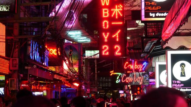 BANGKOK, THAILAND,13 JULY 2019: Vivid neon signs glowing on Soi Cowboy street. Nightlife in erotic Red light district. Illuminated bar and adult go-go show club. Night life tourist entertainment.