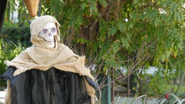 LOS ANGELES, CALIFORNIA, USA - 29 OCT 2019: Scary festival decorations of a house, Happy Halloween holiday. Classic garden with Pumpkin, Bones and Skeleton. Traditional party decor. American culture.