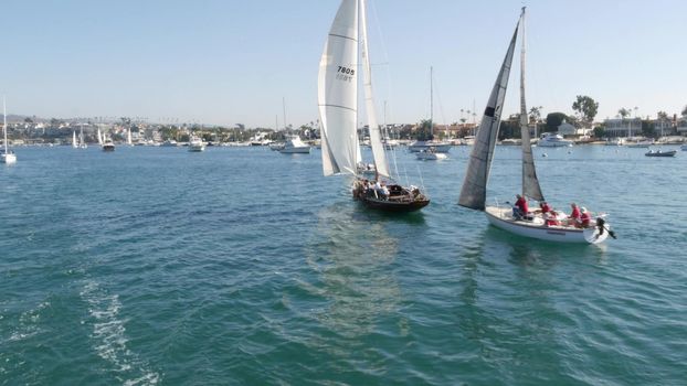 NEWPORT BEACH, CALIFORNIA, USA - 03 NOV 2019: Marina resort with yachts and sailboats, Pacific coast near Los Angeles. Regatta of nautical vessels, sail boat in harbor. Luxury suburb in Orange County.