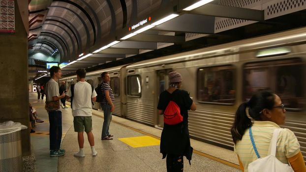 LOS ANGELES, CALIFORNIA, USA - 7 NOV 2019: Metro Rail transportation system. Metropolitan public passenger railway transport infrastructure. Citizens inside underground subway. People in LA City.