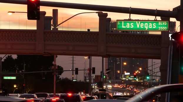 LAS VEGAS, NEVADA USA - 13 DEC 2019: Traffic sign glowing on The Strip in fabulous sin city. Iconic signboard on the road to Fremont street. Illuminated symbol of casino, money playing and betting.