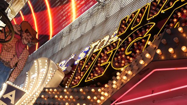 LAS VEGAS, NEVADA USA - 12 DEC 2019: Cowboy Vegas Vic, old neon sign glowing, Freemont street in sin city. Illuminated retro welcoming signboard to Pioneer Club casino. Vintage greeting man at night.