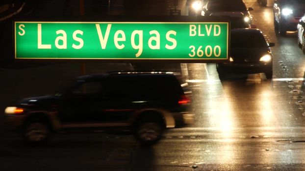LAS VEGAS, NEVADA USA - 13 DEC 2019: Traffic sign glowing on The Strip in fabulous sin city. Iconic signboard on the road to Fremont street. Illuminated symbol of casino, money playing and betting.