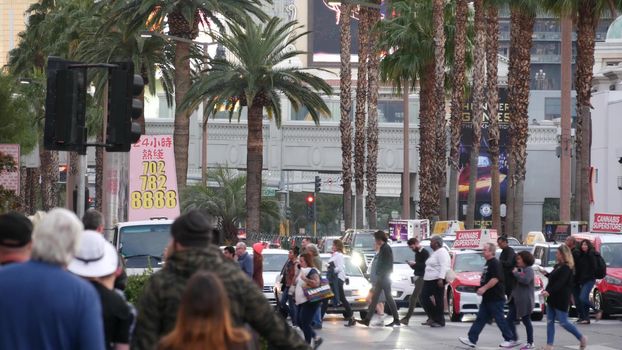 LAS VEGAS, NEVADA USA - 13 DEC 2019: People on pedestrian walkway. Multicultural men and women walking on city promenade. Crowd of citizens on sidewalk. Diversity of multiracial faces in metropolis.