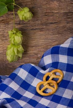 Bavarian Oktoberfest beer and pretzels on wooden table.