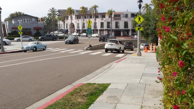 La Jolla, San Diego, CA USA -24 JAN 2020: Cars and buildings, downtown city street of californian coastal tourist resort. Cityscape with traffic, american travel destination for holidays and weekend.