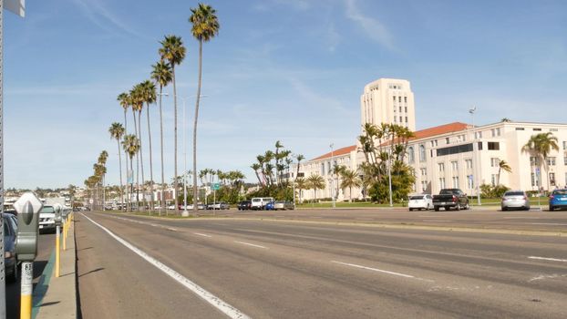 SAN DIEGO, CALIFORNIA USA - 30 JAN 2020: County civic center in downtown. Urban skyline of Gaslamp Quarter. Cityscape of metropolis, pacific harbour waterfront with palm trees. Cars drive on road.