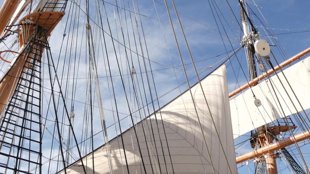 SAN DIEGO, CALIFORNIA USA - 30 JAN 2020: Retro sailing ship Star of India, full rigged wooden masts of Maritime Museum. Historic British frigate with white sails and ropes. Old large barque sailboat.