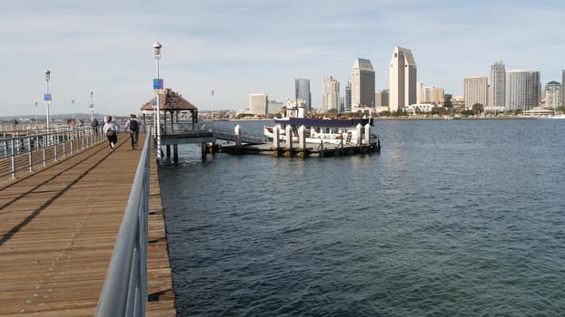 SAN DIEGO, CALIFORNIA USA - 30 JAN 2020: Silvergate passenger ferry boat near pier, Coronado island landing, Flagship public transportation. Metropolis urban skyline, highrise skyscrapers near harbor.