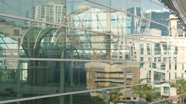 SAN DIEGO, CALIFORNIA USA - 13 FEB 2020: Contemporary Convention Center building, reflection of urban skyline in mirror glass wall. Highrise skyscrapers of Gaslamp Quarter in downtown of metropolis.