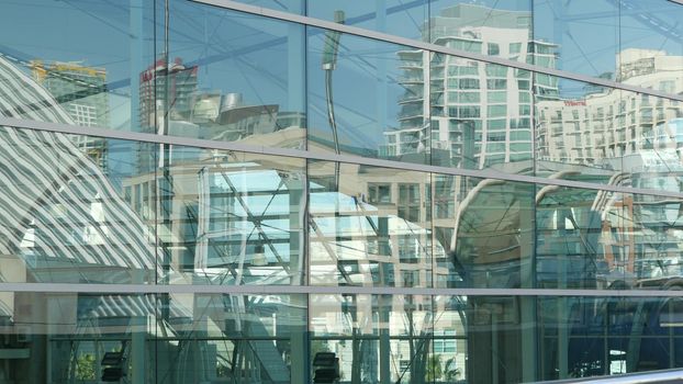 SAN DIEGO, CALIFORNIA USA - 13 FEB 2020: Contemporary Convention Center building, reflection of urban skyline in mirror glass wall. Highrise skyscrapers of Gaslamp Quarter in downtown of metropolis.