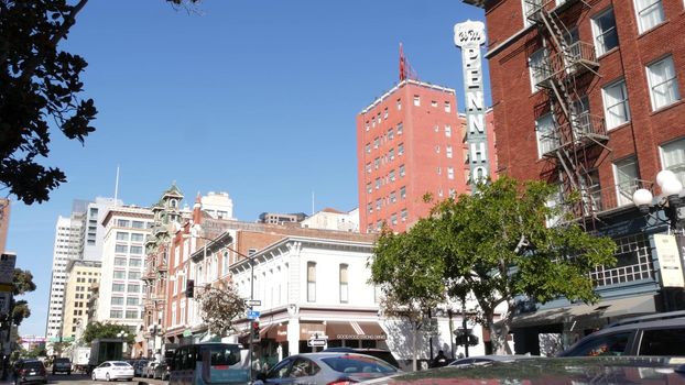 SAN DIEGO, CALIFORNIA USA - 13 FEB 2020: Pedestrians, traffic and highrise buildings in city downtown. Street life of american metropolis. Urban street, transport and citizens walking on walkways.