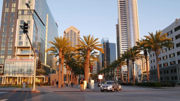 SAN DIEGO, CALIFORNIA USA - 13 FEB 2020: Pedestrians, traffic and highrise buildings in city downtown. Street life of american metropolis. Urban Broadway street, transport and citizens near Santa Fe.