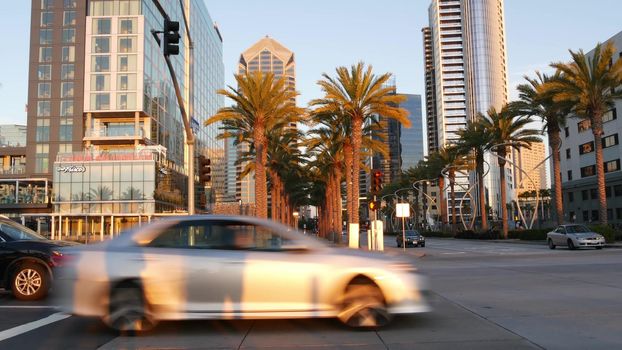 SAN DIEGO, CALIFORNIA USA - 13 FEB 2020: Pedestrians, traffic and highrise buildings in city downtown. Street life of american metropolis. Urban Broadway street, transport and citizens near Santa Fe.