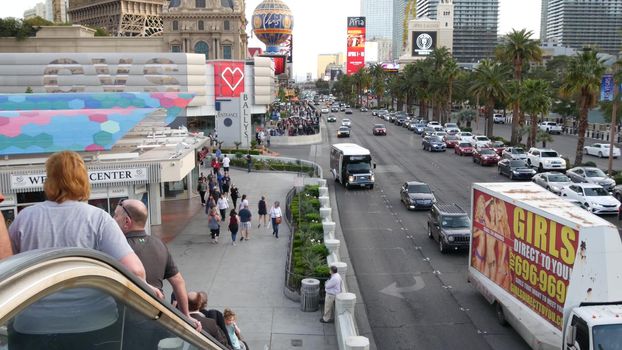 LAS VEGAS, NEVADA USA - 5 MAR 2020: The Strip boulevard with luxury casino and hotels in gambling sin city. Car traffic on road to Fremont street in tourist money playing resort. People walking.