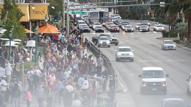 LAS VEGAS, NEVADA USA - 5 MAR 2020: People on pedestrian walkway. Multicultural men and women walking on city promenade. Crowd of citizens on sidewalk. Diversity of multiracial faces in metropolis.