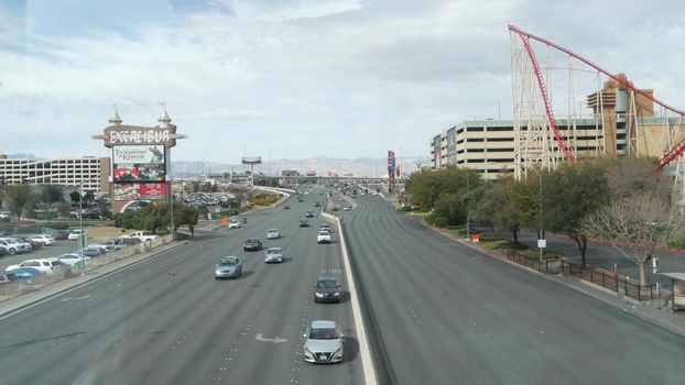 LAS VEGAS, NEVADA USA - 7 MAR 2020: Sin city in Mojave desert from above. Traffic highway in valley with arid climate. Aerial view of road in tourist metropolis. Gambling and betting area with casino.