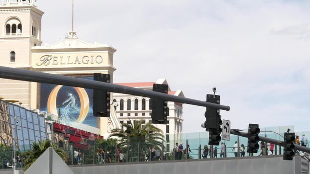 LAS VEGAS, NEVADA USA - 7 MAR 2020: People on pedestrian skyway. Multicultural men and women walk on skybridge. Crowd of citizens on pedway. Diversity of multiracial tourists on skywalk in metropolis.