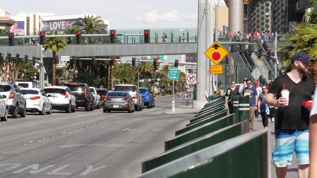 LAS VEGAS, NEVADA USA - 7 MAR 2020: People on pedestrian walkway. Multicultural men and women walking on city promenade. Crowd of citizens on sidewalk. Diversity of multiracial faces in metropolis.