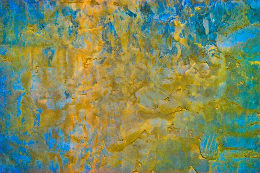 Concrete background in blue-yellow color with large heterogeneous texture.