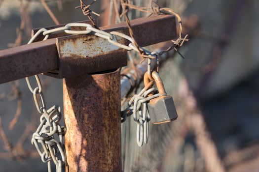 Blurred background with rusty metal wire and lock. For design and networking.